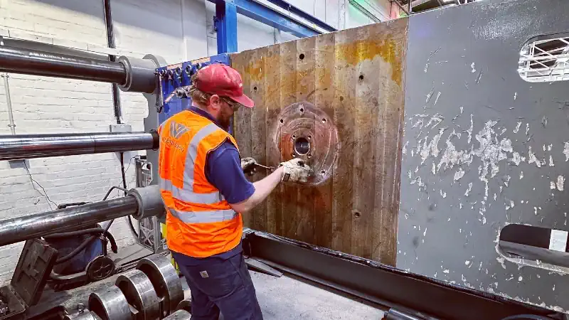 Industrial Process Solutions & Repairs. Man Removing Bolts From Industrial Machine.