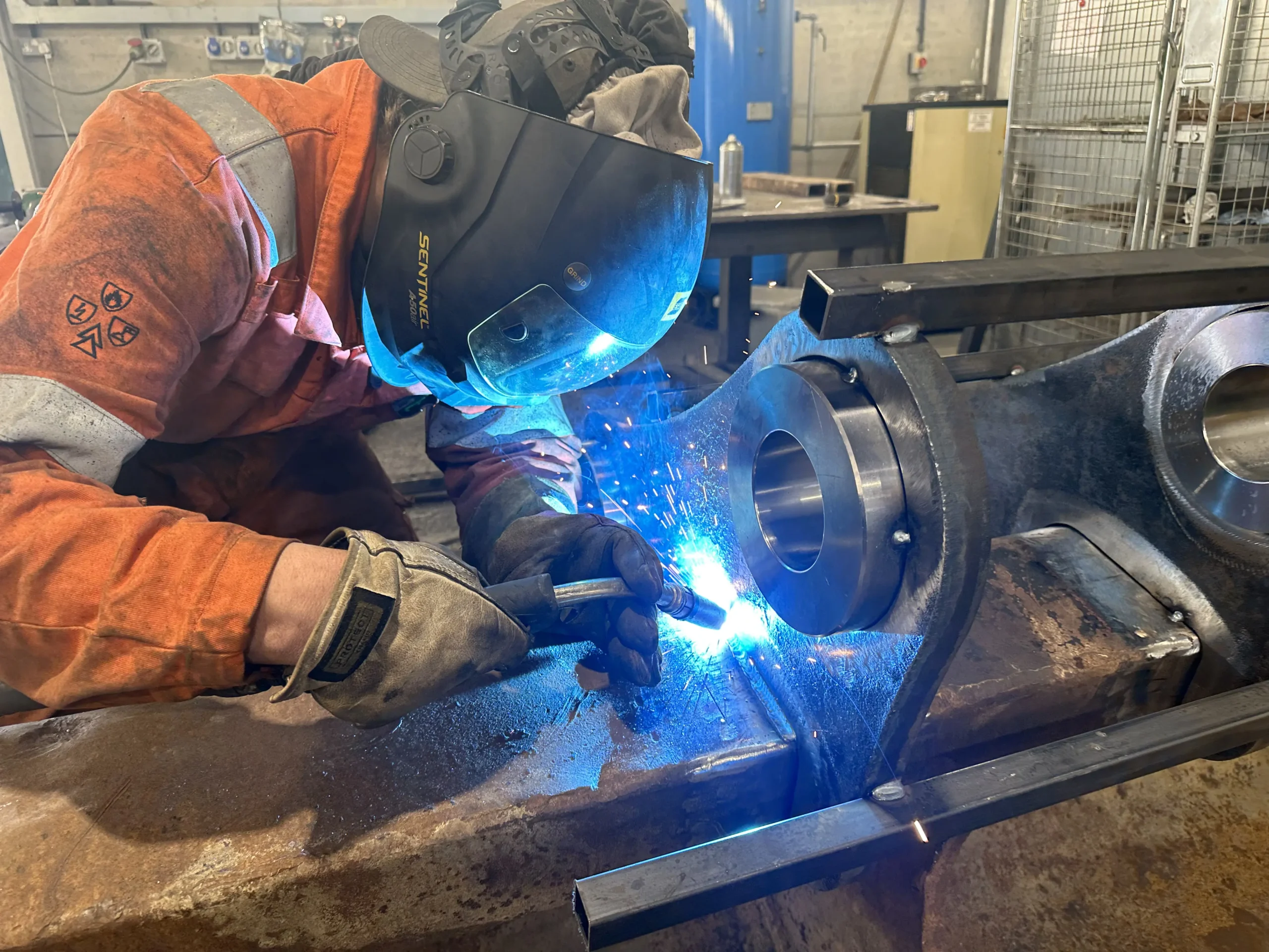 Custom Fabrication and Modifications. Man Welding Axle Mounts.