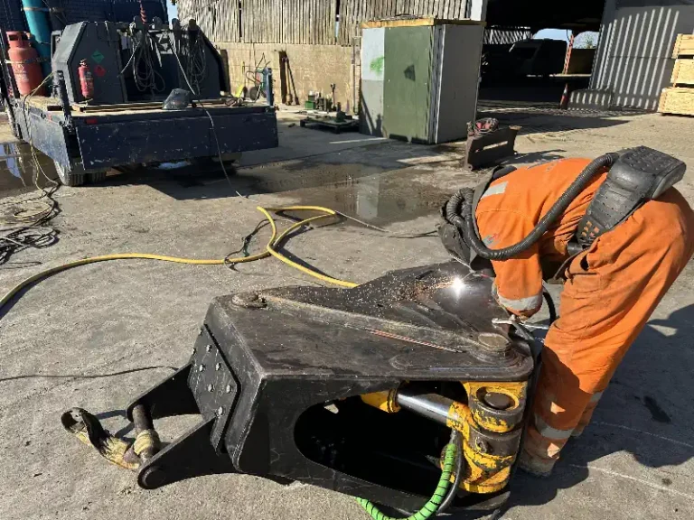 Forestry Equipment Welding Repair. Man Welding Forestry Attatchment.