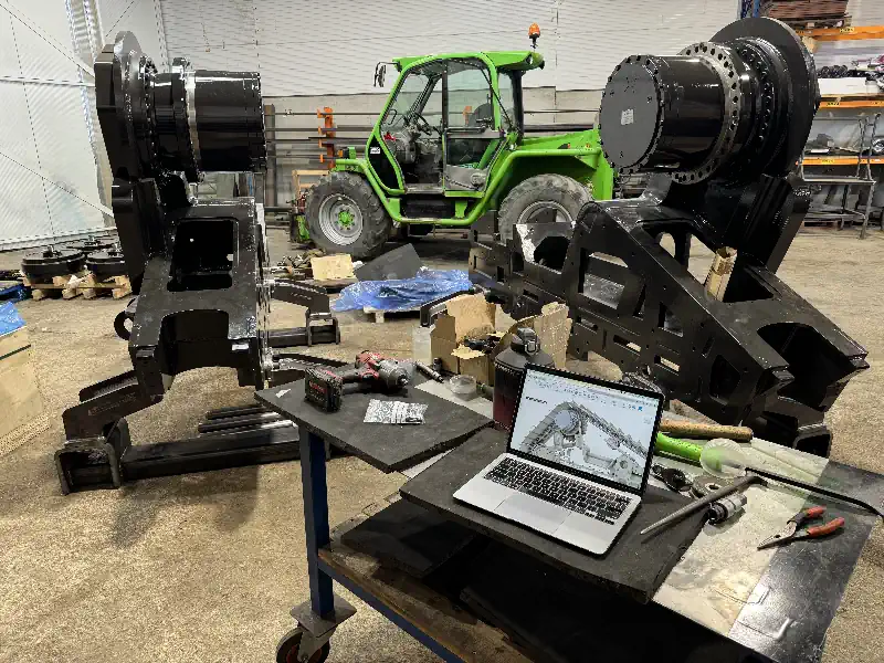 Custom Parts and Machinery. Workshop With Produced parts on display and drawings on laptop for comparison.